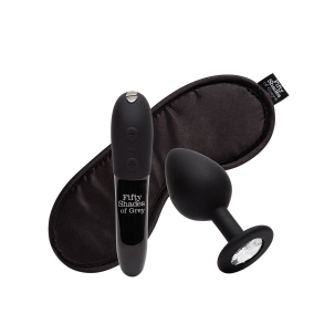 Fifty Shades of Grey vibrator Fifty Shades X We- Come to Bed 3pc Couple's Kit shown in hand for scale