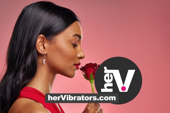 Rose Vibrator Shop Online Woman smelling a red rose for a guide to choosing the best rose vibrator