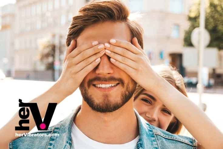 A couple engaging in intimate exploration with a strap-on harness, symbolizing trust and new sexual experiences.