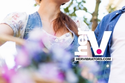 bottle of green anal sex lube with soft natural elements to represent gentle plant-inspired anal lubrication