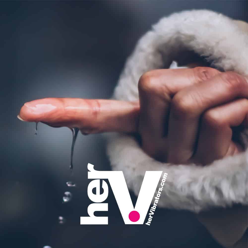 A finger catching water droplets, personal lubricant.