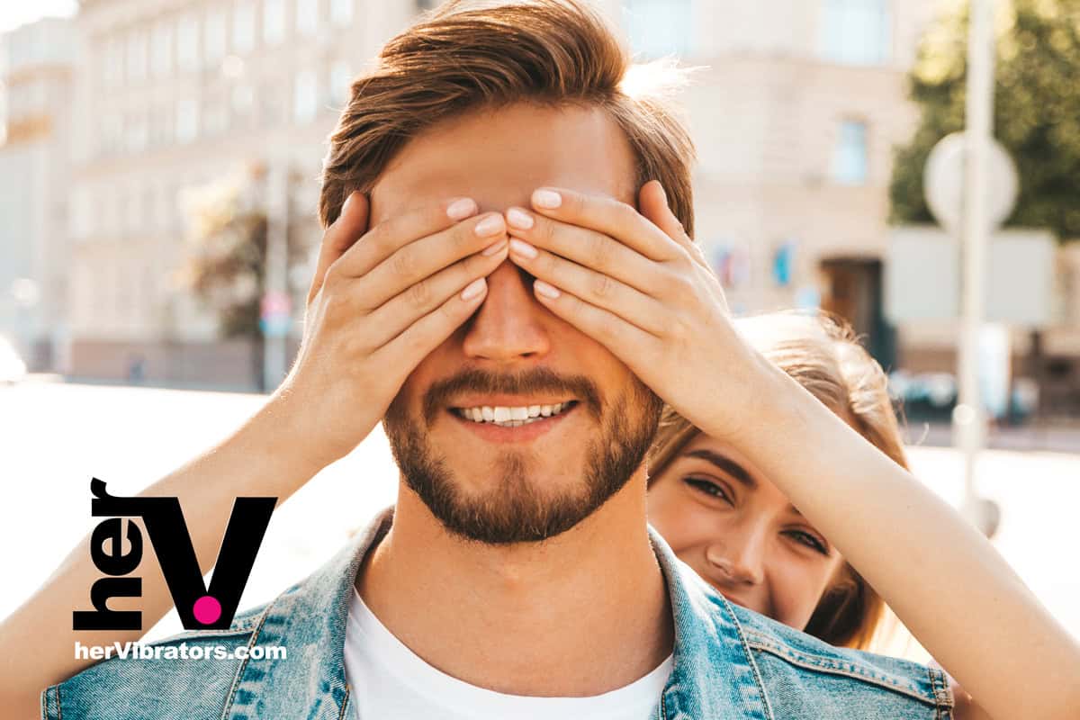 A couple engaging in intimate exploration with a strap-on harness, symbolizing trust and new sexual experiences.