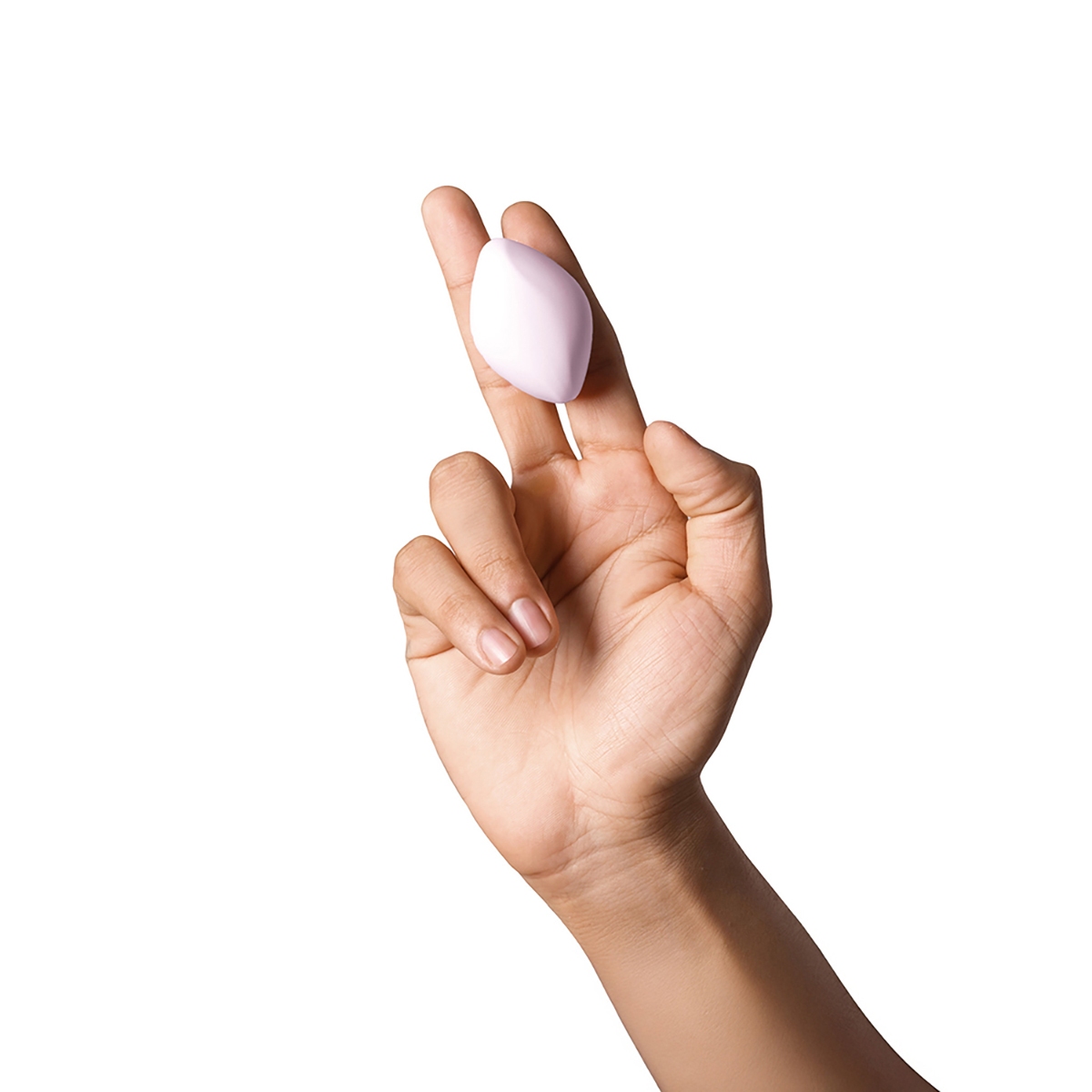 Lifestyle shot featuring the  Dame Products vibrator beside the bed