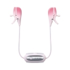 Lovense vibrator Gemini Nipple Clamps shown in hand for scale