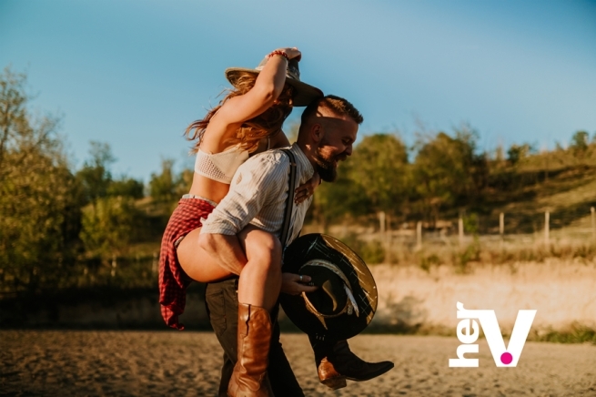 Reverse cowgirl sex position guide showing a couple exploring a playful rear-facing position outdoors