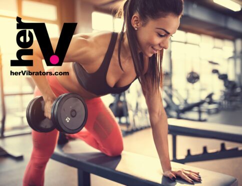 A fit woman wearing a black sports bra and red leggings performs a dumbbell row in a gym, illustrating the benefits of ben wa balls for pelvic floor strength.
