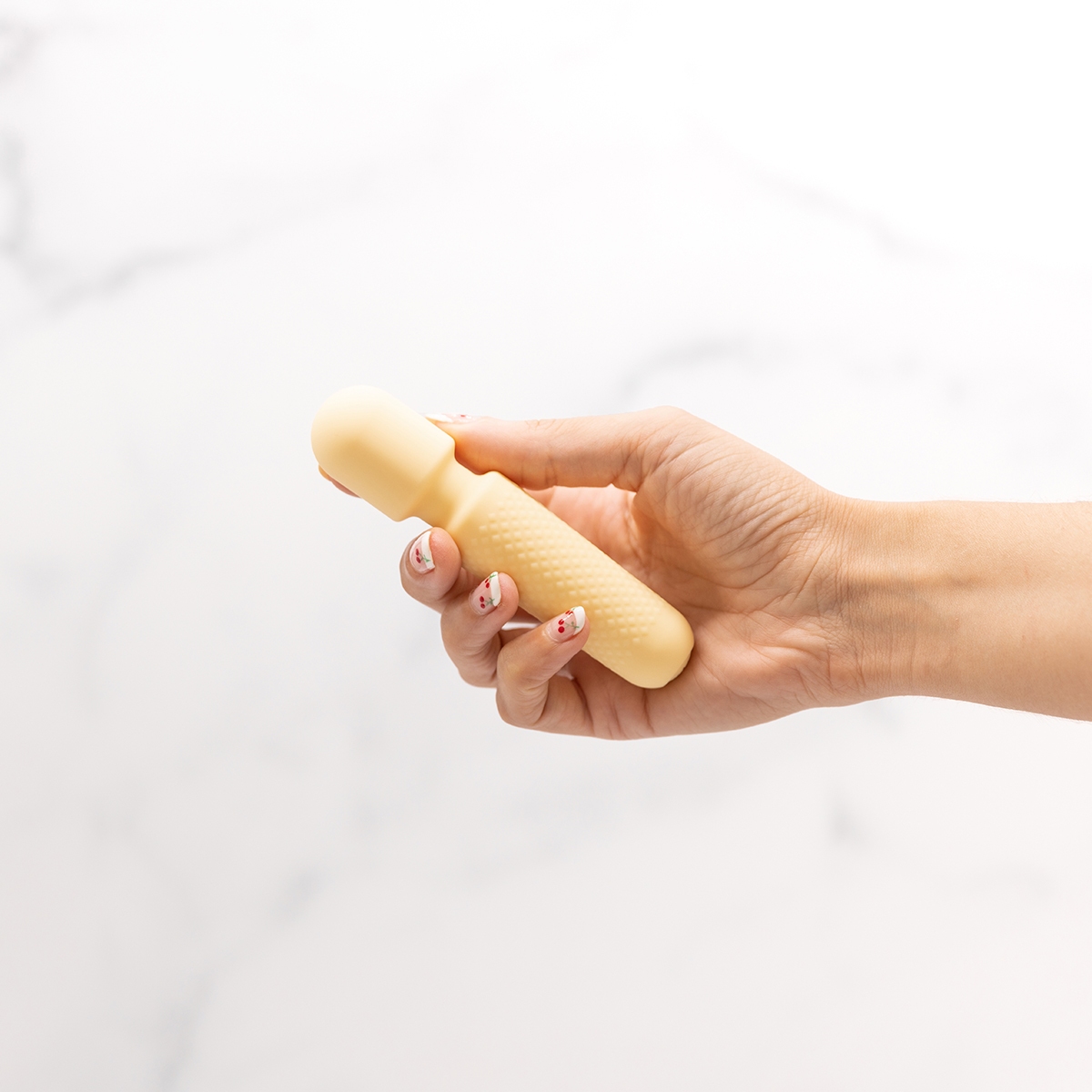 Close-up of the Cream Emojibator vibrator for texture detail