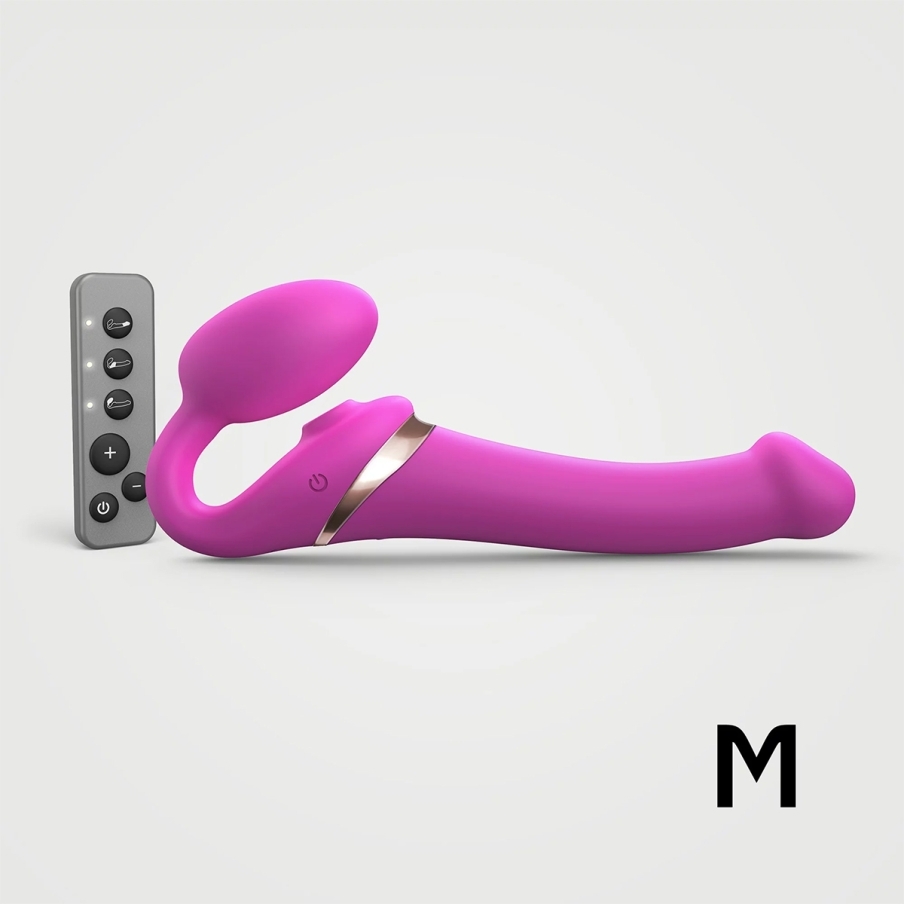 Multi Strap-On-Me vibrator Orgasm Medium Bendable Strap-On Fuchsia shown in hand for scale