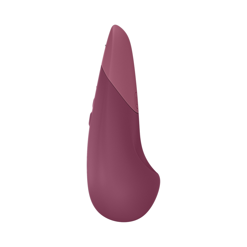 Lifestyle shot featuring the Pink Womanizer vibrator beside the bed