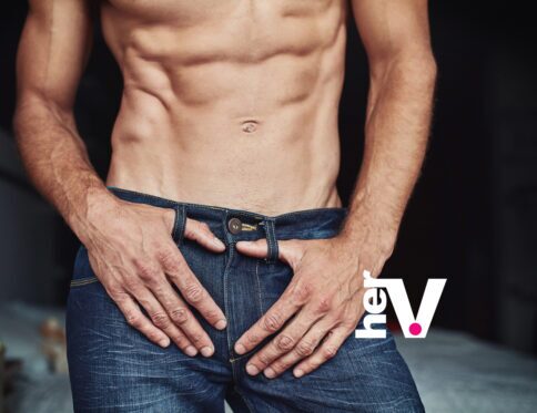 Man wand male pleasure lifestyle image featuring a shirtless man with jeans partially open, representing vibrating strokers, male stimulation, and modern sexual wellness